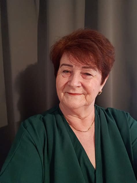 Ilustračná fotografia ženy v strednom veku s miernym úsmevom, symbolizujúca prijatie a pohodu.